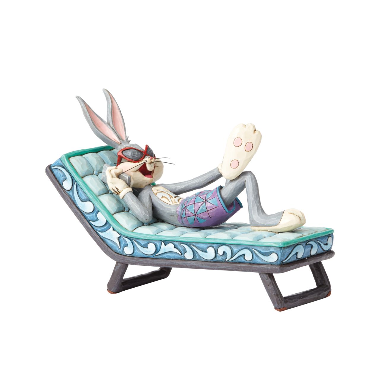 Movie mogul Bugs Bunny catches some rays in this whimsical scene from Looney Tunes. Handcrafted in rich detail, this poolside rabbit is beautifully decorated with the quilt patterns and folk-art style that are unmistakably Jim Shore.