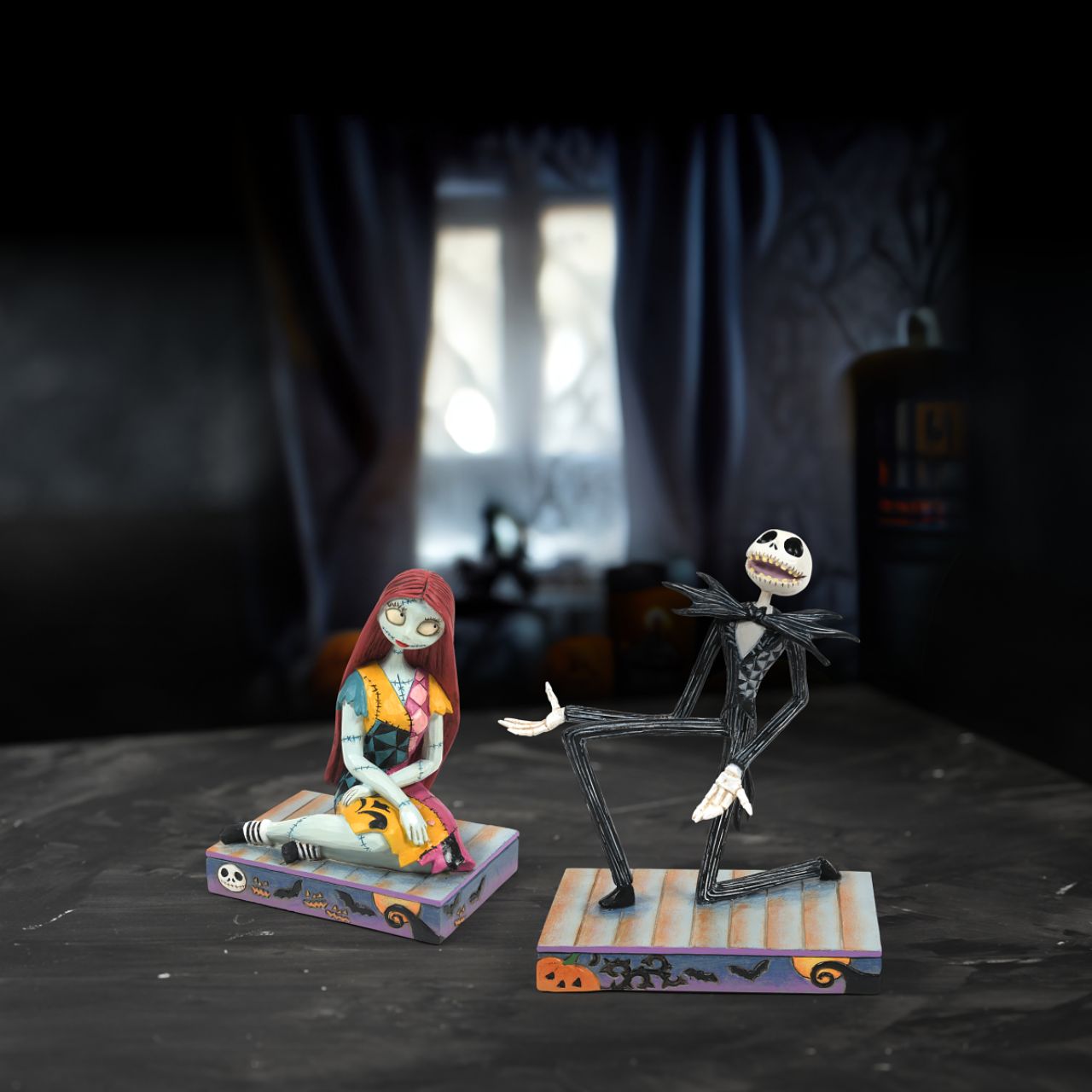 Jack Skellington is down on one knee and looks delighted. in his iconic black and white stripe suit and Bat bow-tie, he is on a Halloween themed base, even featuring a Jack-O-Lantern peeking out of the corner.