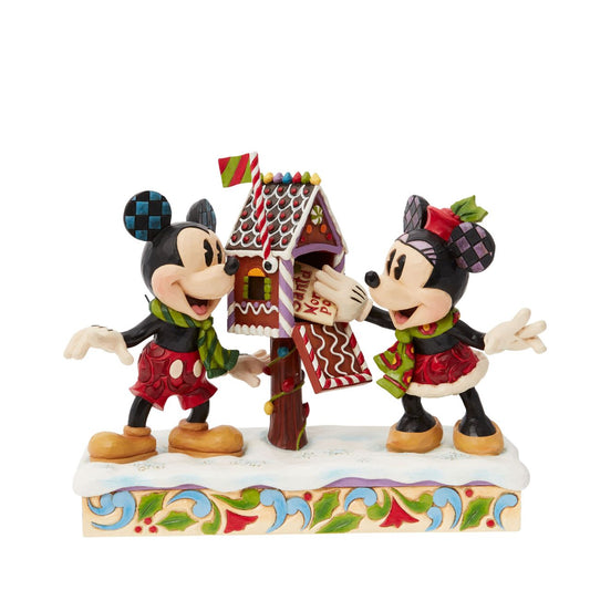 Mickey & Minnie Mouse are in the Christmas Spirit with Disney Traditions by Jim Shore. A beautiful, festive figurine featuring the iconic couple posting their Christmas letter off to Santa. Hand carved and hand painted. Comes in a fully branded gift box.