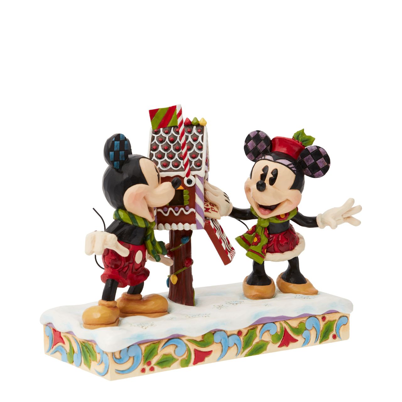 Mickey & Minnie Mouse are in the Christmas Spirit with Disney Traditions by Jim Shore. A beautiful, festive figurine featuring the iconic couple posting their Christmas letter off to Santa. Hand carved and hand painted. Comes in a fully branded gift box.