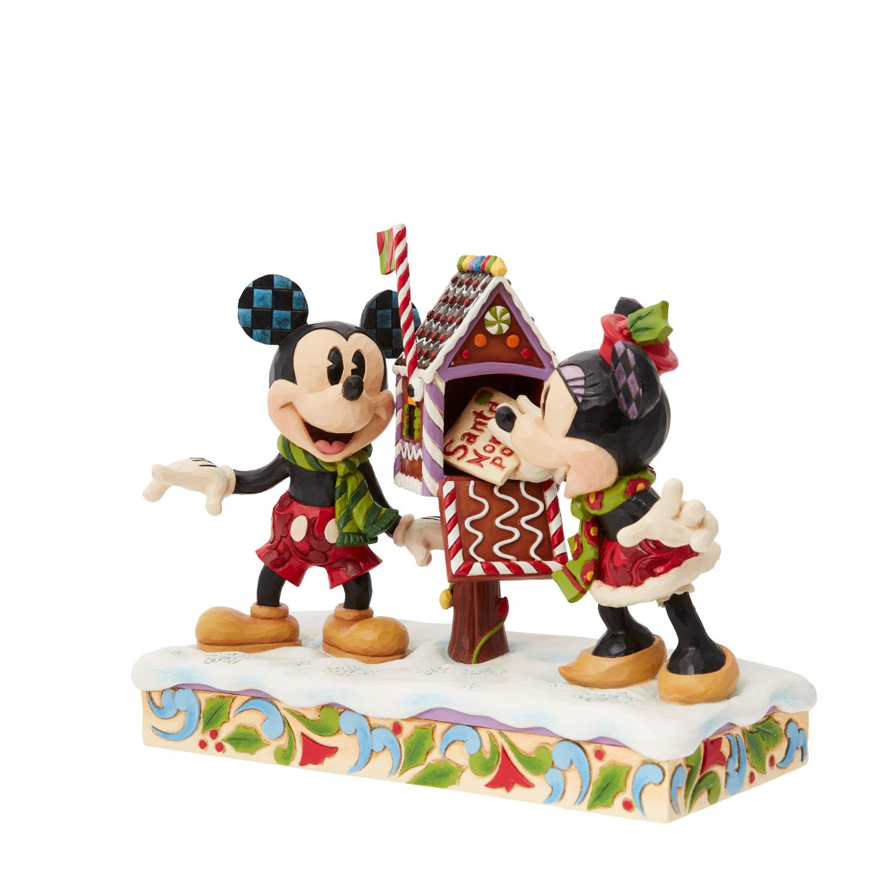 Mickey & Minnie Mouse are in the Christmas Spirit with Disney Traditions by Jim Shore. A beautiful, festive figurine featuring the iconic couple posting their Christmas letter off to Santa. Hand carved and hand painted. Comes in a fully branded gift box.