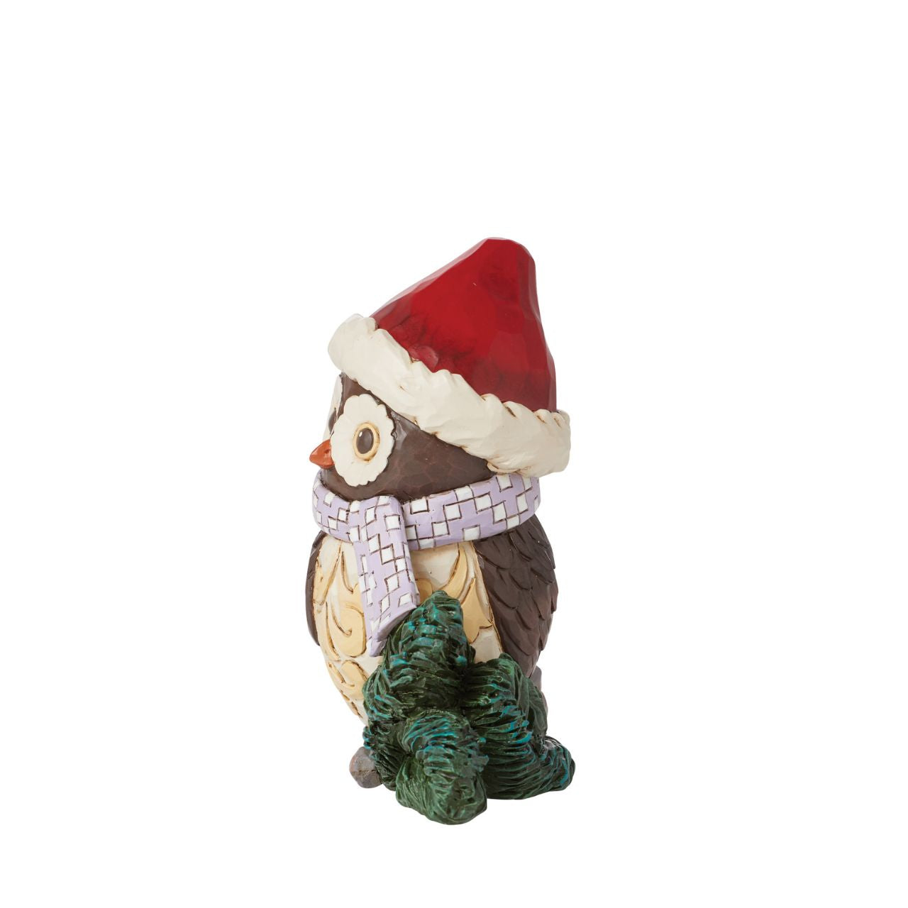 This miniature owl figurine wears a patchwork blue scarf with a Santa hat. With wide eyes and sweet expression, the little owl perches near pine needles with a rosemaling bust. This charming Jim Shore figurine is sure to make your holidays a hoot!