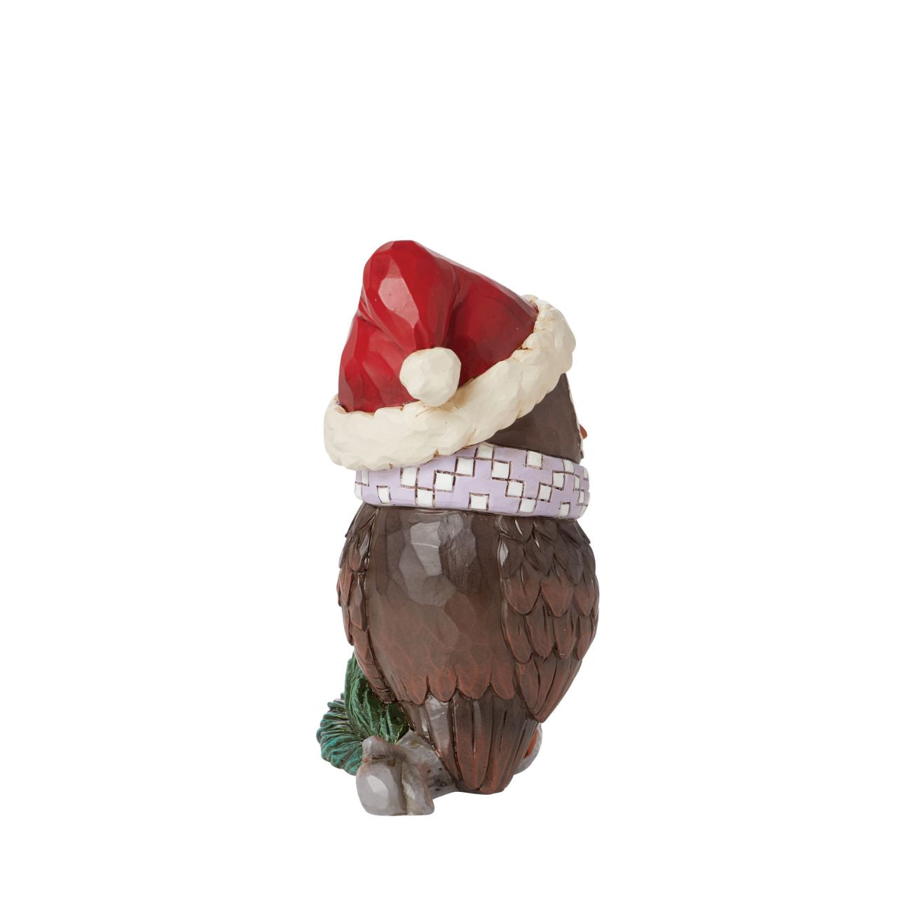 This miniature owl figurine wears a patchwork blue scarf with a Santa hat. With wide eyes and sweet expression, the little owl perches near pine needles with a rosemaling bust. This charming Jim Shore figurine is sure to make your holidays a hoot!