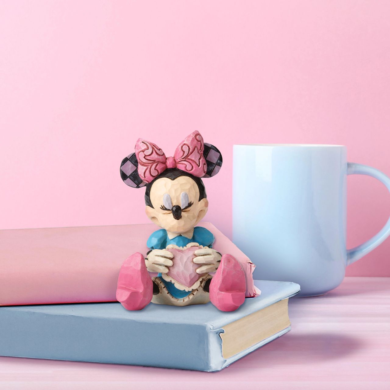 Beautifully handcrafted with delightful attention to detail, Jim Shore's charming miniatures capture the essence of the beloved Disney characters. Making a wish on a heart held close, this beguiling Minnie is a heartfelt and playful romantic design.