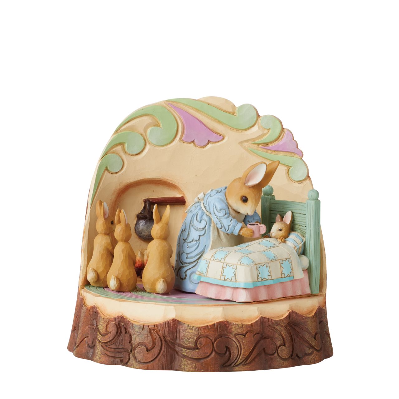 In this beautifully crafted figurine by Jim Shore, we get a glance inside the Rabbit household on a cozy night. Tucking her littlest bunny into bed, Mrs. Rabbit tends to sleepy child while her three other youngsters huddle excitedly by the fire.