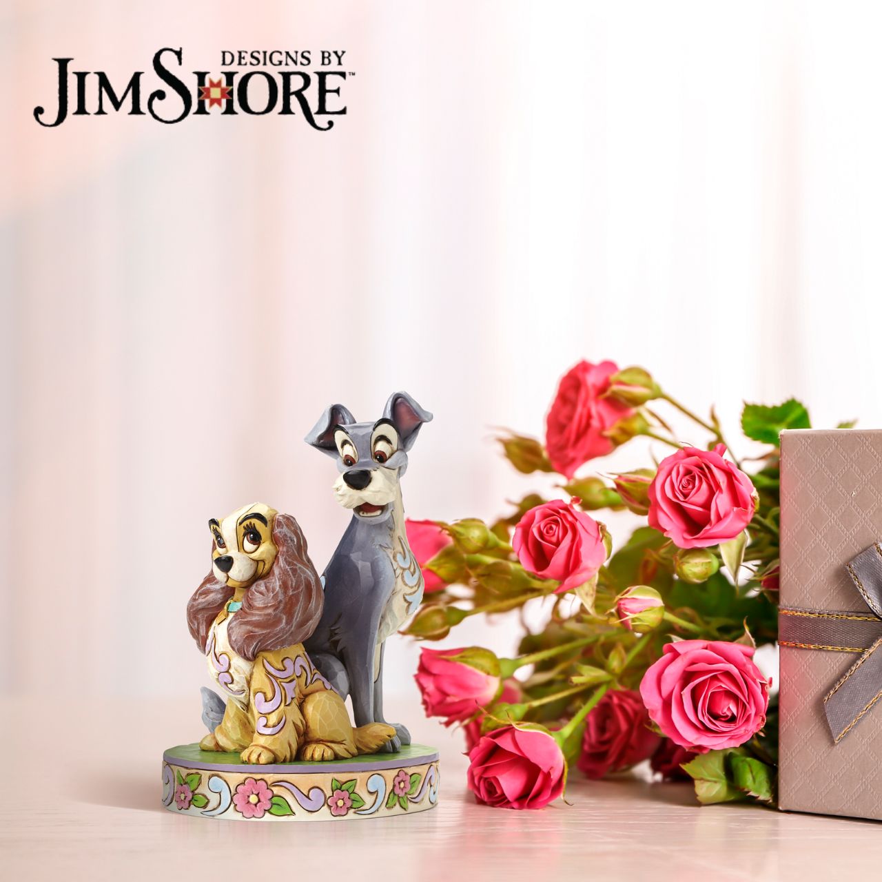 Disney Traditions Lady and The Tramp 60th Anniversary Piece  To celebrate the 60th Anniversary of Disney's romantic classic Lady and the Tramp. Jim Shore celebrates this historic milestone with a special figurine capturing the two characters in a lovable pose. Available only from the Disney Traditions brand.