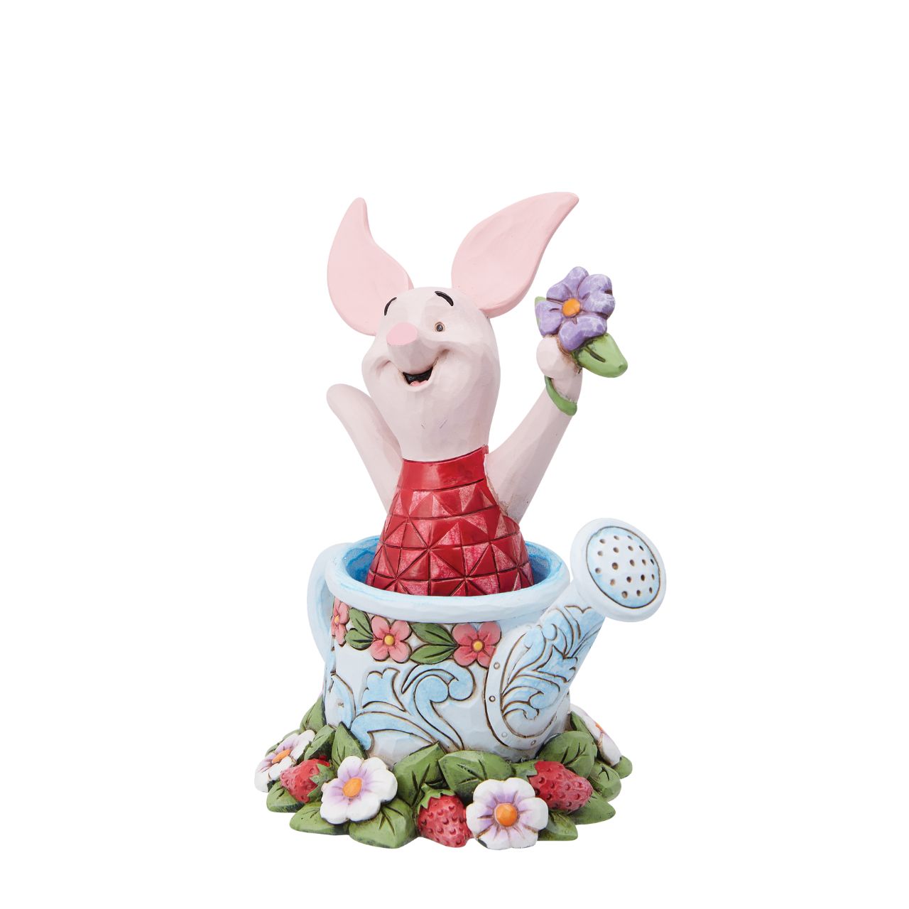 Piglet in a Watering Can Figurine  Introducing the delightful Piglet in a Watering Can Figurine from Disney Traditions by Jim Shore. Dressed in his signature pink jumper, this lovable character is holding a beautiful, pastel purple flower in his hand. This charming figurine is whimsical and heart-warming, bringing joy and magic to any collection of Disney figurines.