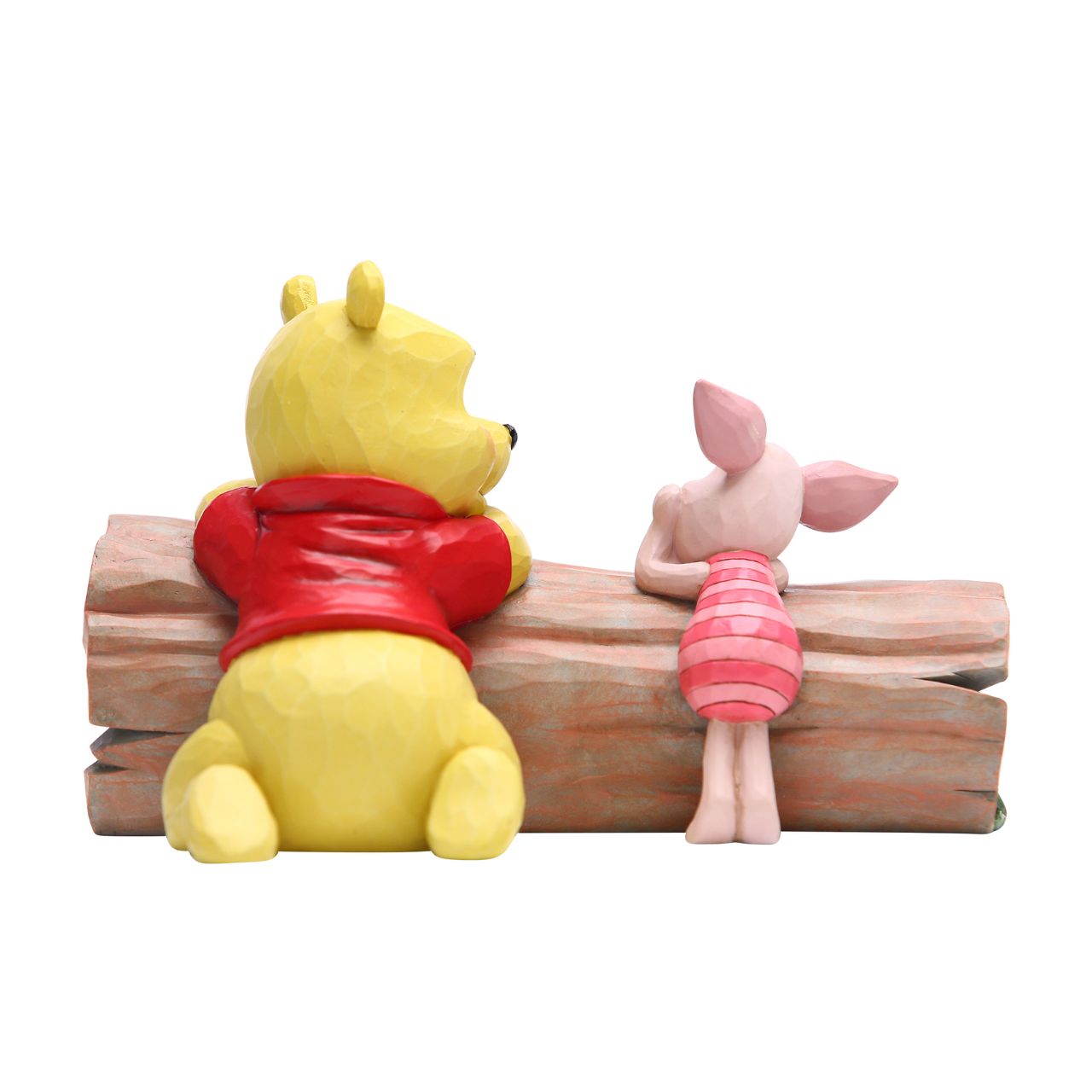 Jim Shore's Pooh and Piglet on a Log Figurine Truncated Conversation  Friends Winnie the Pooh and Piglet share a thoughtful moment together in the One Hundred Acre Wood. Folk art-inspired details add to the artisanal charm of this hand-painted figurine, sculpted from high-quality cast stone.