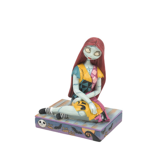 Sally from The Nightmare before Christmas is sat delicately on a Halloween themed base, which even features the face of her paramour, Jack Skellington. Designed by Jim Shore for Disney Traditions. The perfect gift for any fan. Comes in fully branded gift box.