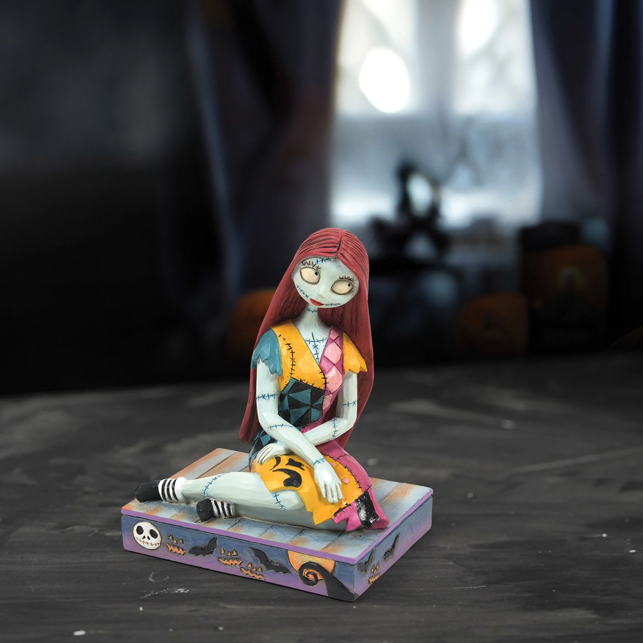 Sally from The Nightmare before Christmas is sat delicately on a Halloween themed base, which even features the face of her paramour, Jack Skellington. Designed by Jim Shore for Disney Traditions. The perfect gift for any fan.