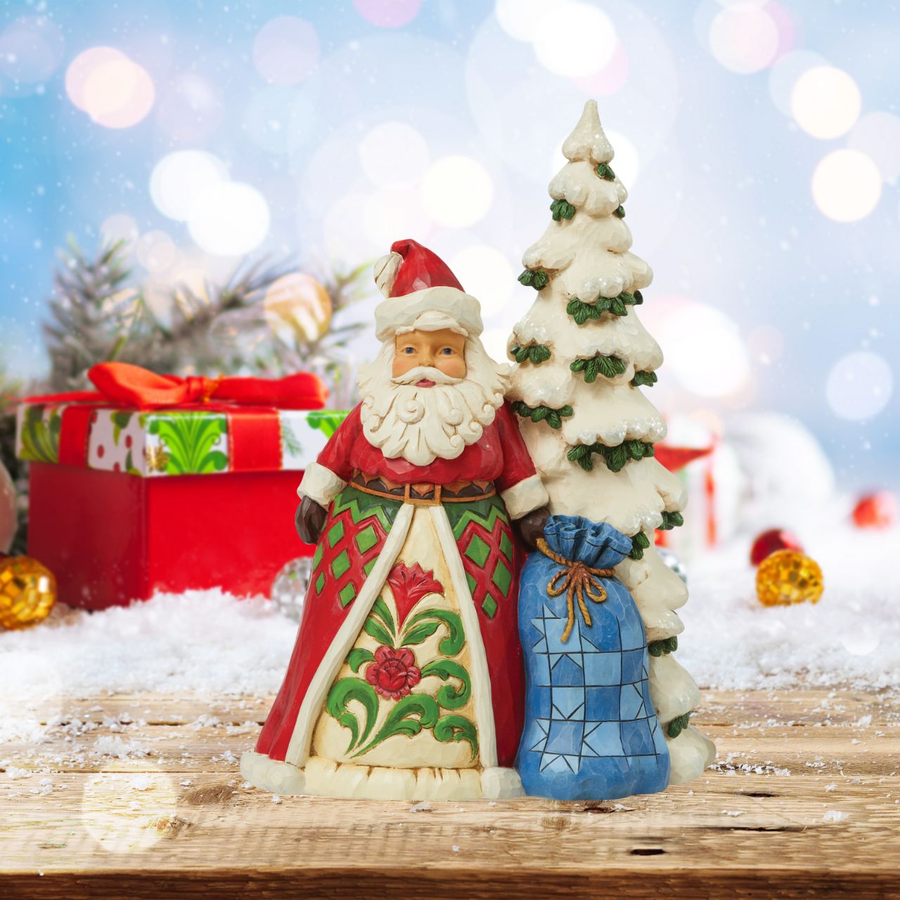 Heartwood Creek Santa by Tree with Toy Sack Figurine  Designed by award winning artist Jim Shore as part of the Heartwood Creek Christmas Collection, hand crafted using high quality cast stone and hand painted, this Santa by tree is perfect for the Christmas season.