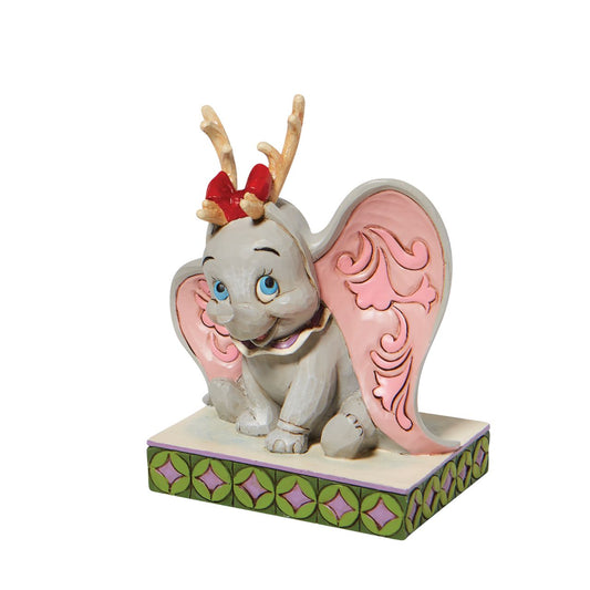  "Santa's Cheerful Helper" Dumbo, the sweetest elephant with the largest ears, dons antlers to help deliver presents this season. Already gifted with the power of flight, he'll make a lovely reindeer for Santa's sleigh in this Jim Shore classic. 