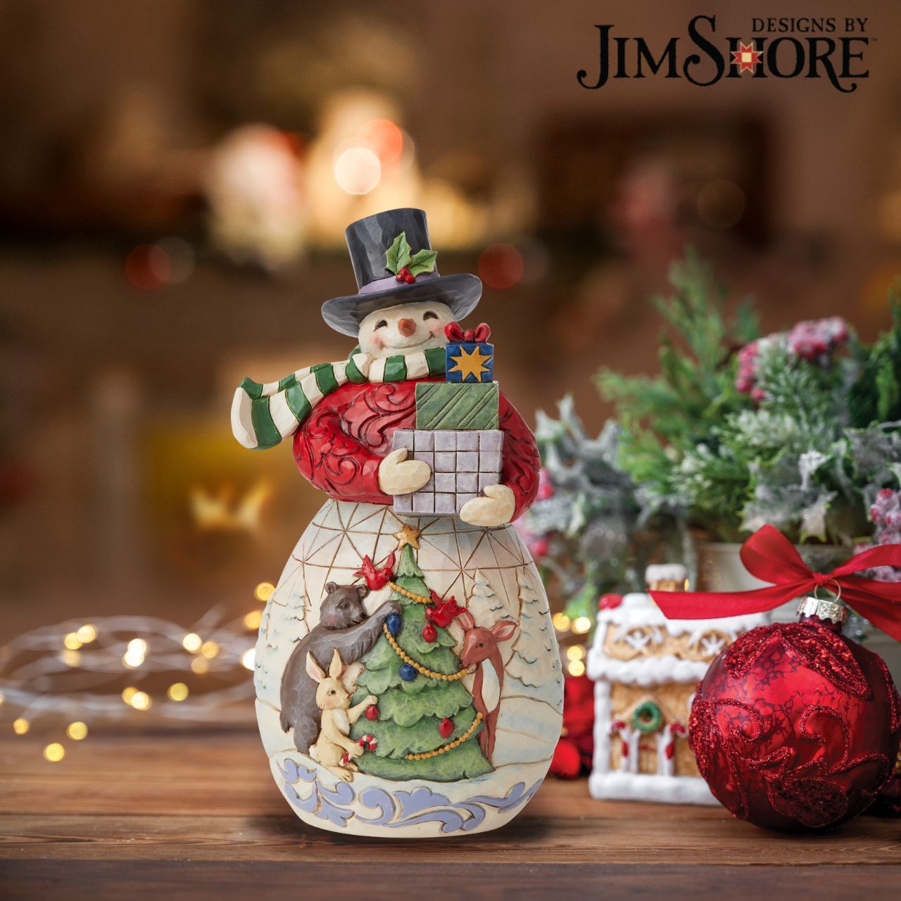 Snowman with Gifts Figurine by Jim Shore   Designed by award winning artist Jim Shore as part of the Heartwood Creek Christmas Collection, hand crafted using high quality cast stone and hand painted, this Snowman with gifts is perfect for the Christmas season. 