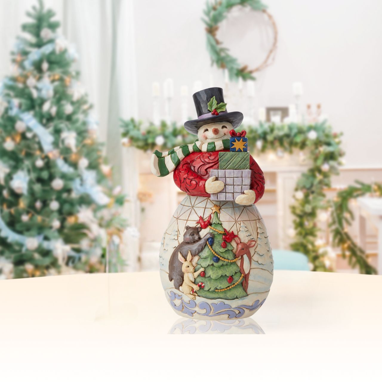 Snowman with Gifts Figurine by Jim Shore   Designed by award winning artist Jim Shore as part of the Heartwood Creek Christmas Collection, hand crafted using high quality cast stone and hand painted, this Snowman with gifts is perfect for the Christmas season. 