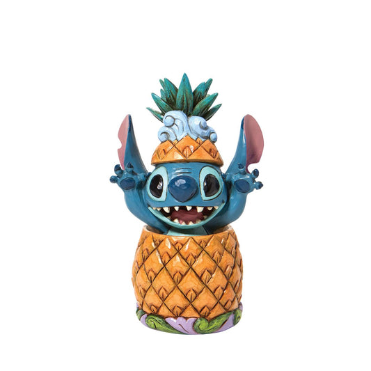 "Pineapple Pal" Popping cheerfully out a pineapple, Stitch celebrates the day and the twenty year anniversary of the film that brought him into our hearts. Wearing the pineapple top as a hat, the cheerful alien reaches for a hug. Make him apart of your Ohana today.