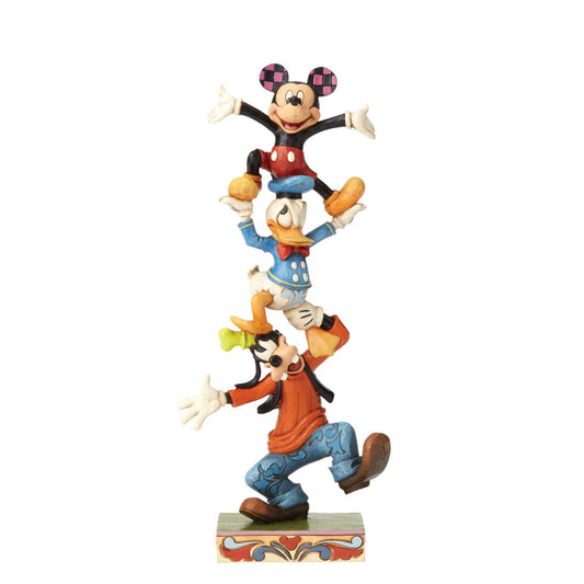 This stacked design features Goofy, a choleric Donald Duck and a triumphant Mickey Mouse on top. This cast stone figurine is beautifully handcrafted in the whimsical folk art style that is unmistakably Jim Shore.