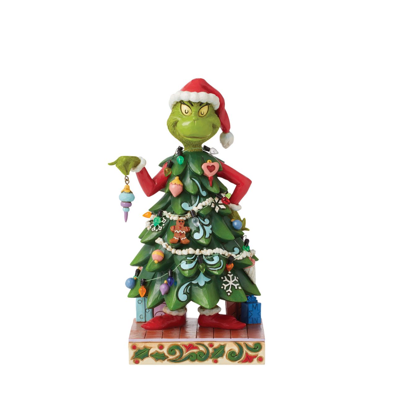 With a heart enlarged with holiday spirit and love, The Grinch smiles sincerely in this festive Jim Shore design. Dressed as a Christmas tree, Grinch wears a Santa hat and holds an ornament. This piece brings warmth to winter with decorative details.