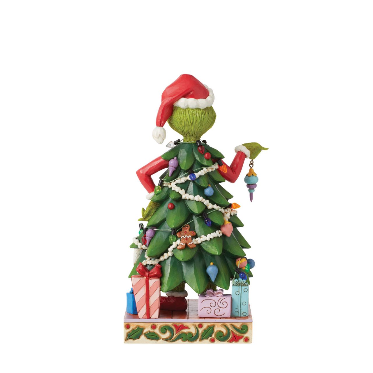 With a heart enlarged with holiday spirit and love, The Grinch smiles sincerely in this festive Jim Shore design. Dressed as a Christmas tree, Grinch wears a Santa hat and holds an ornament. This piece brings warmth to winter with decorative details.