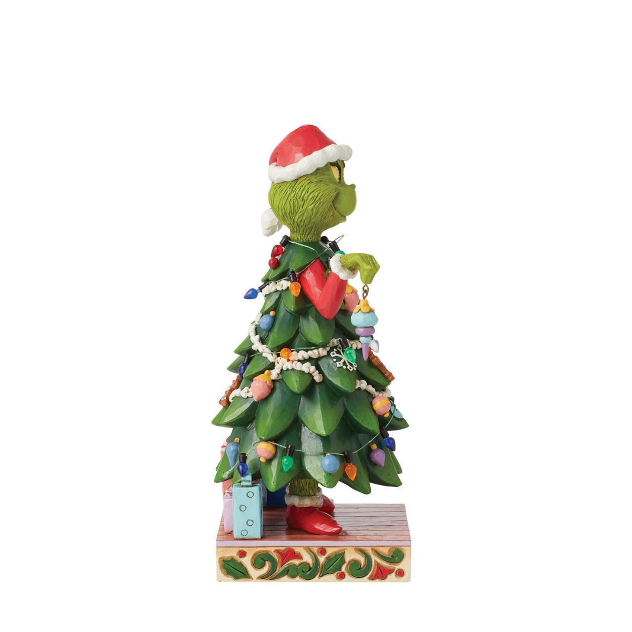 With a heart enlarged with holiday spirit and love, The Grinch smiles sincerely in this festive Jim Shore design. Dressed as a Christmas tree, Grinch wears a Santa hat and holds an ornament. This piece brings warmth to winter with decorative details.