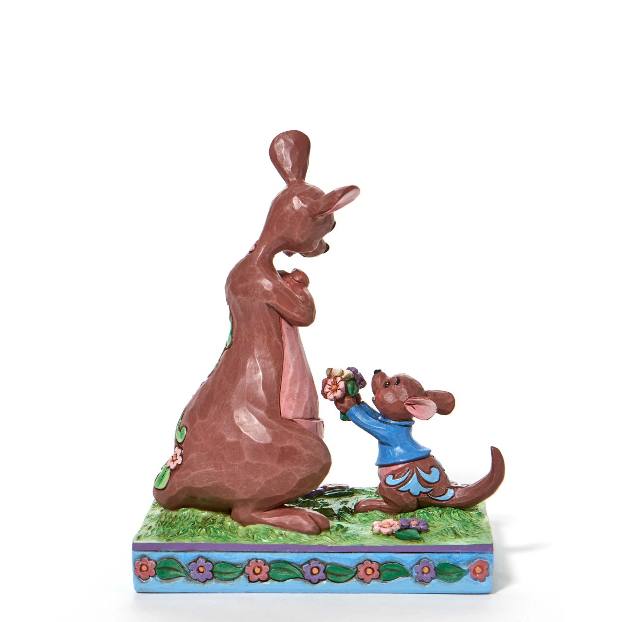 "The Sweetest Gift" The Winnie the Pooh crew enjoy Spring in the Hundred Acre Wood. Kanga and Roo pick wild flowers in the crisp morning air. Engraved with flowers and patchwork, the Jim Shore modelled kangaroo accepts her joey's freshly picked gift with a smile.