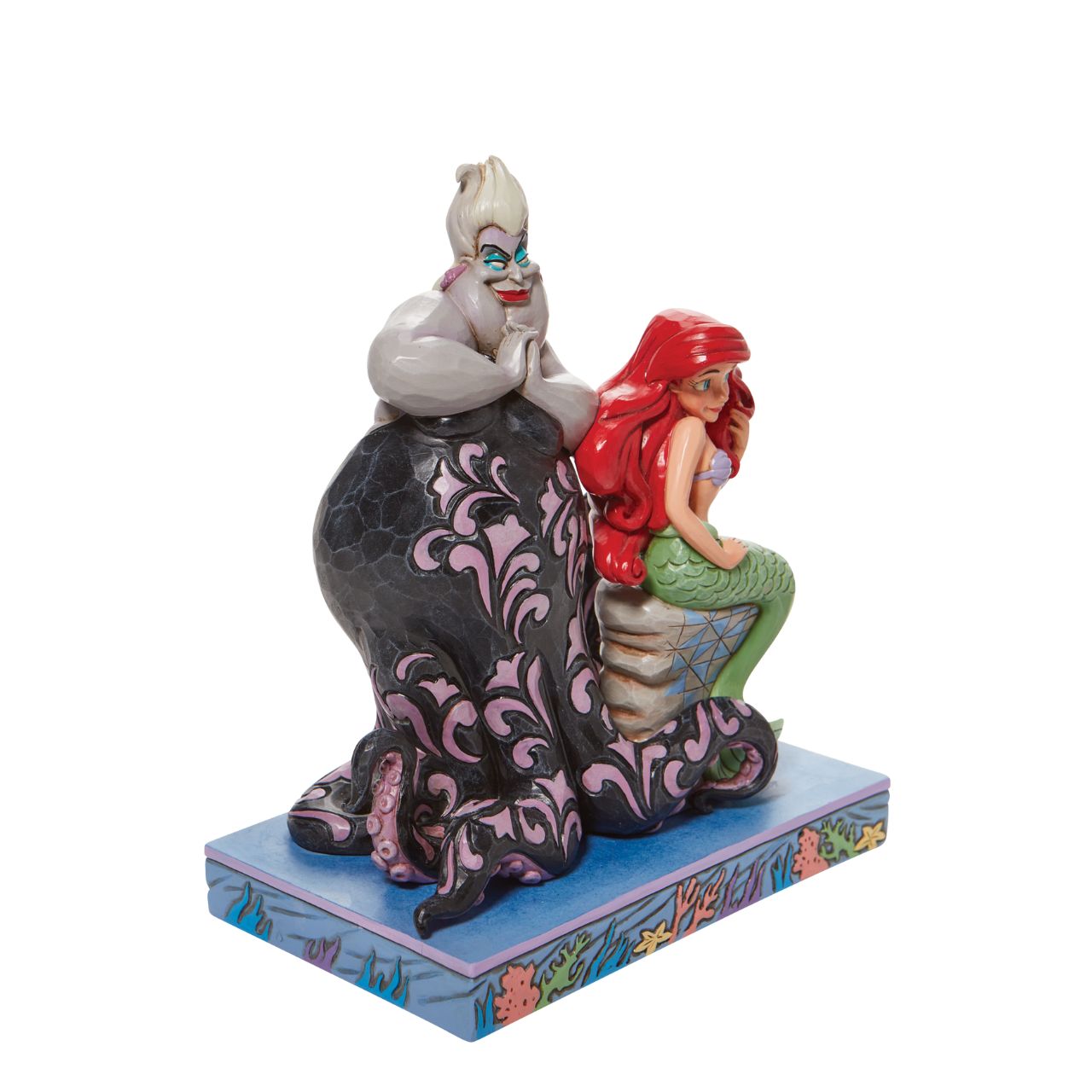 This Jim Shore piece ventures under the sea to share a scene of good and evil. Smiling innocently, Ariel, the little mermaid, sits on a stump as the sea witch, Ursula, connives cruelly behind her shoulder. Packaged in a branded gift box.