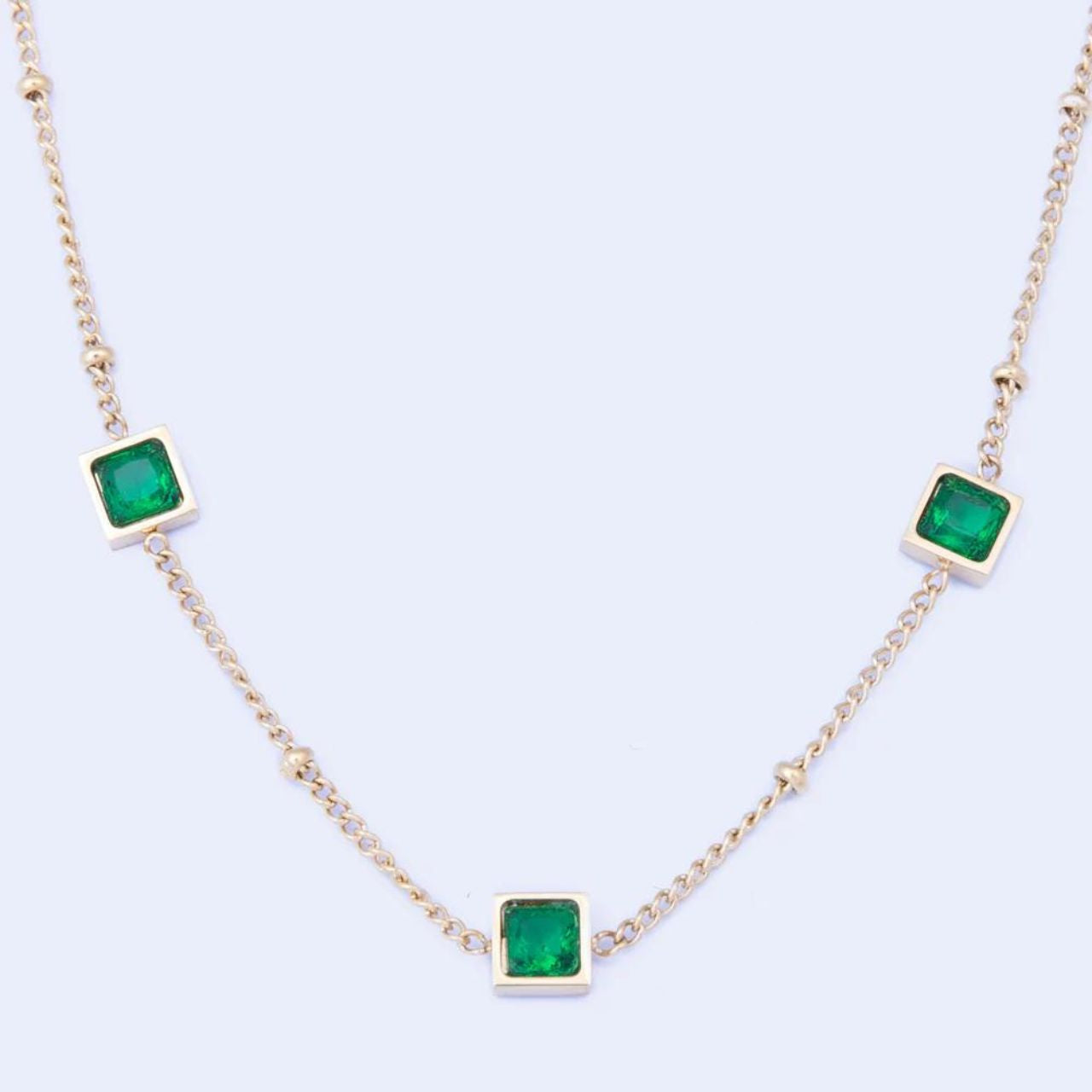 Leilani Emerald Necklace by Knight & Day   The Knight & Day Leilani Emerald Necklace is plated with luxurious 14K yellow gold for a stylish yet timeless look. The lustrous green stones provide a radiant contrast and create a striking statement piece.