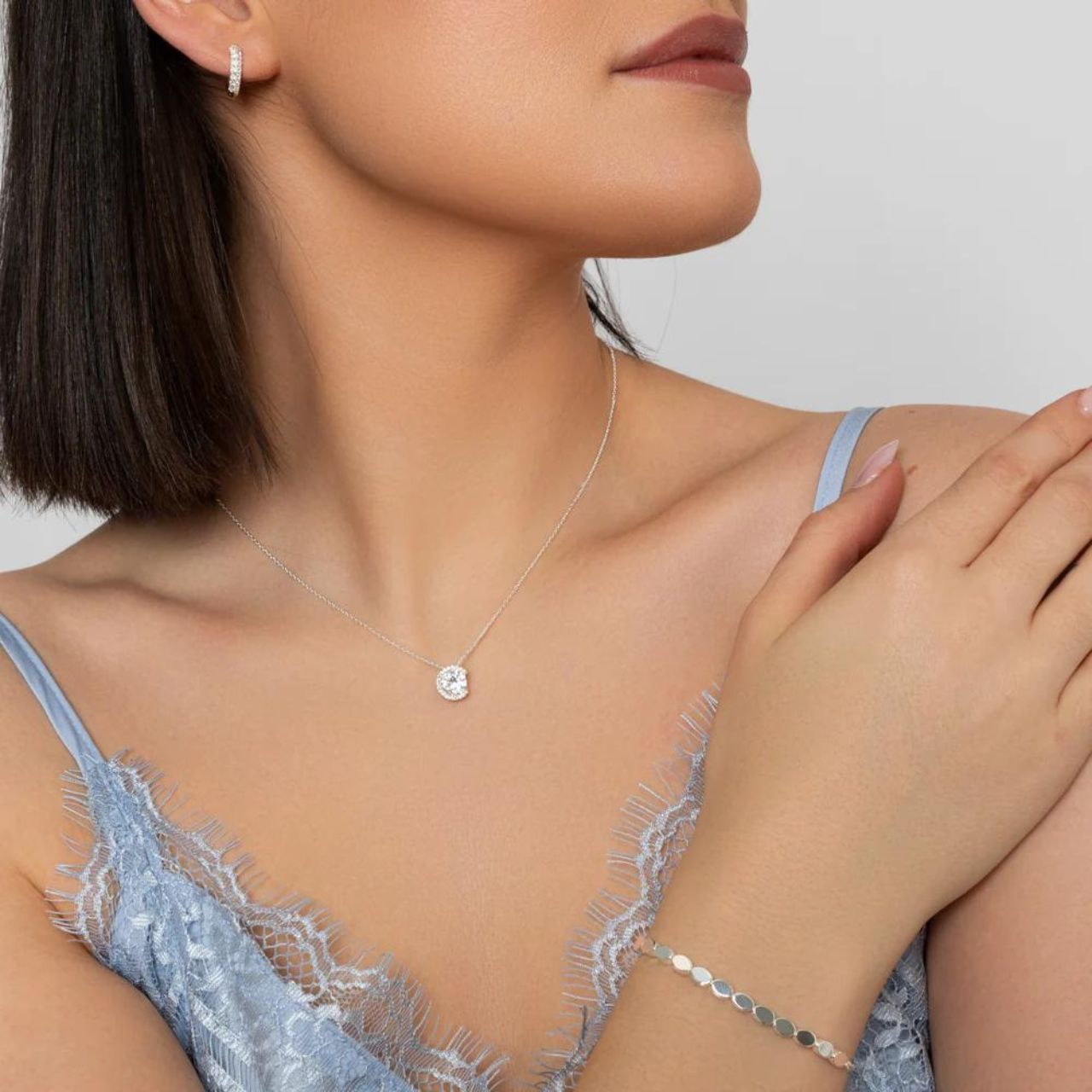 Elevate any outfit with the Silver Solitaire Pendant. This stunning pendant, crafted by Knight & Day, adds a touch of elegance with its silver design. Perfect for any occasion, this pendant exudes sophistication and style. Elevate your look today.