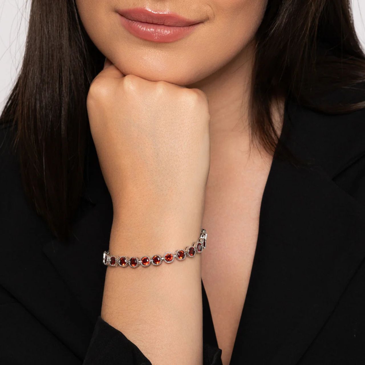 Beautiful rhodium plated tennis bracelet with Garnet CZ stones. Fold over clasp fastening.