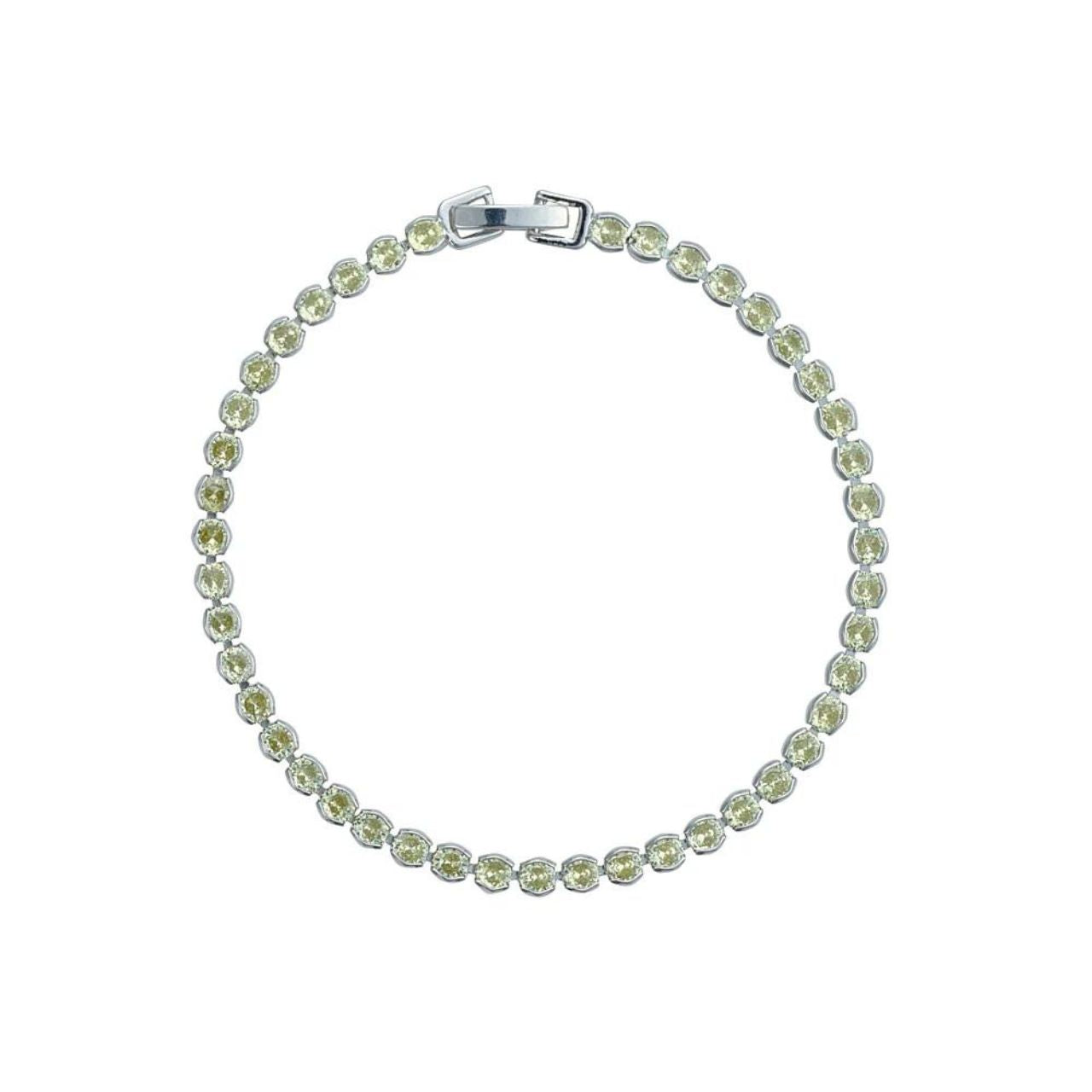 Miniature rhodium plated tennis bracelet with Apple Green CZ stones. Elegant when worn alone and also ideal for layering with watch or other bracelets. Fold over clip fastening.