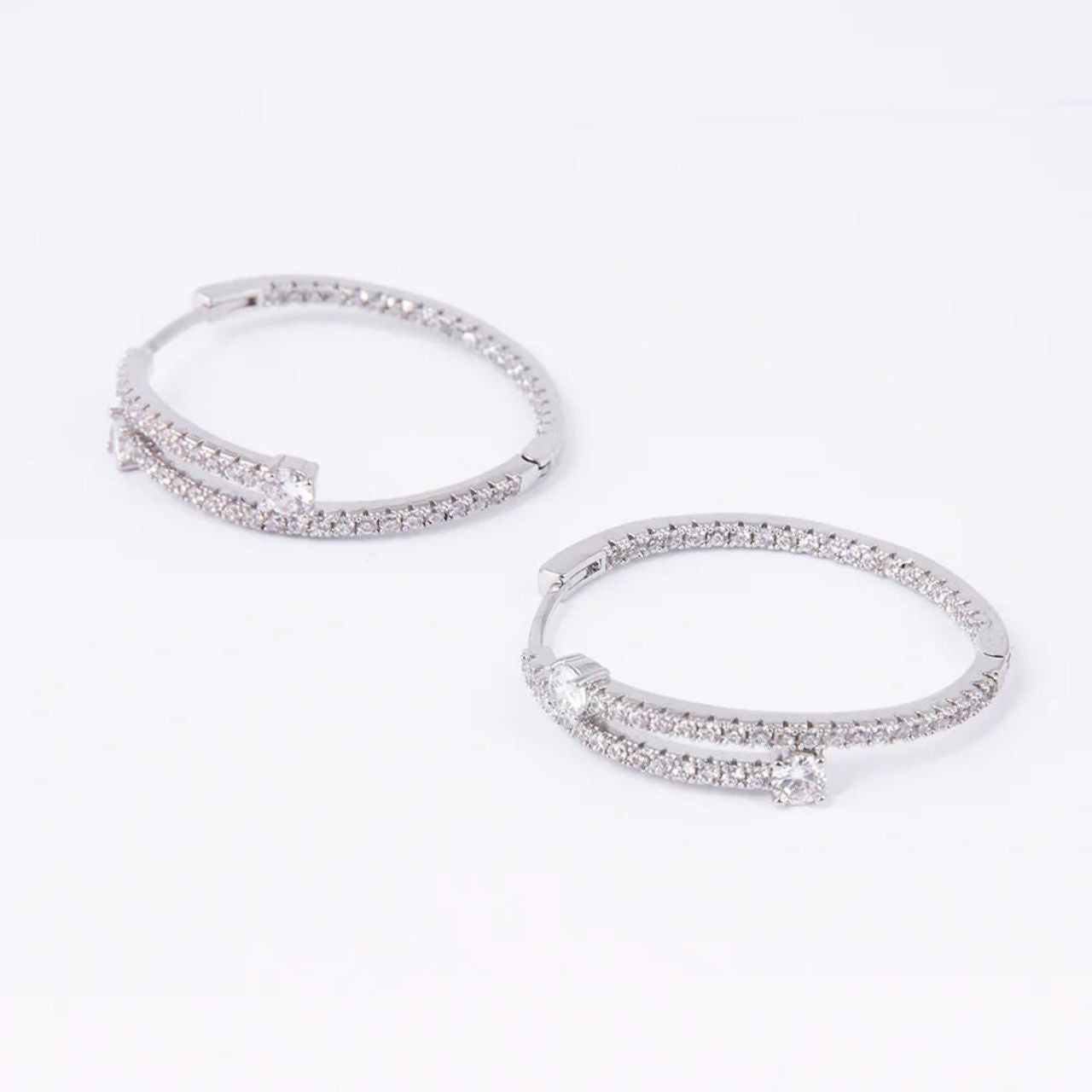 Rhodium Emily Hoop Earrings by Knight & Day  Add a touch of sparkle to any look with Knight & Day's Rhodium Emily Hoop Earrings. Crafted from rhodium for a lasting shimmer, these unique earrings will add a sophisticated touch to any outfit.