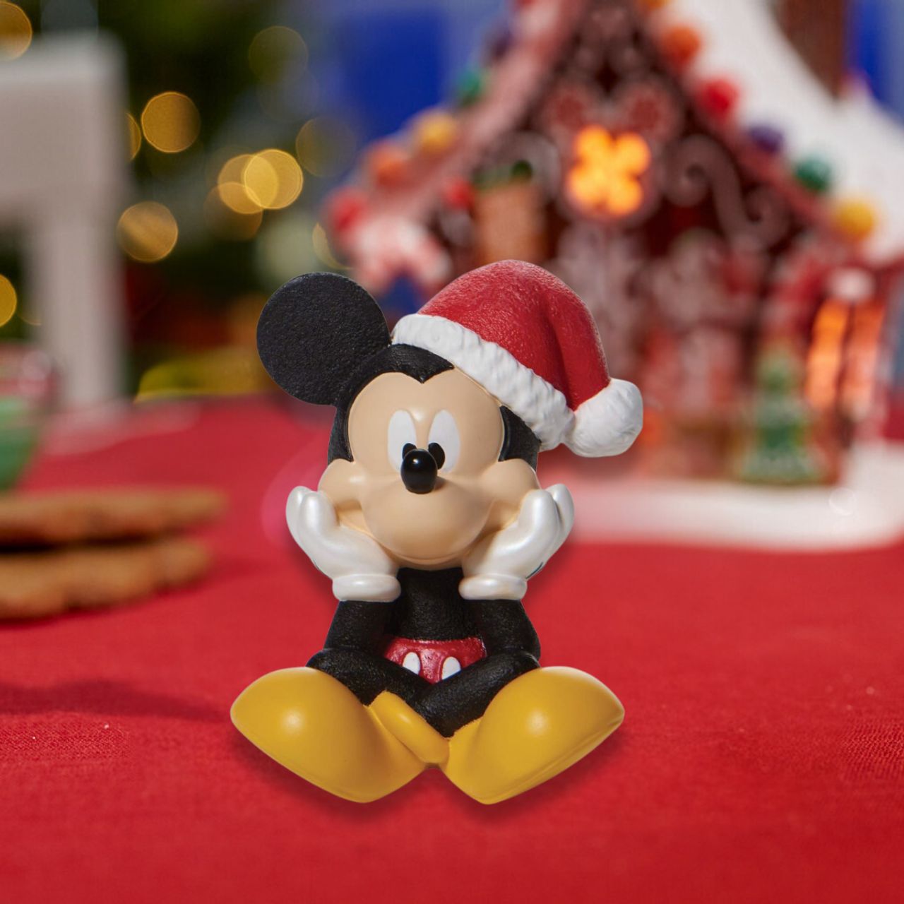 Positively jolly, Mickey Mouse excitedly sits in this beautiful Christmas figure from Disney. With a song in his heart and holly in his hat, Mickey prepares to spend the season smiling.