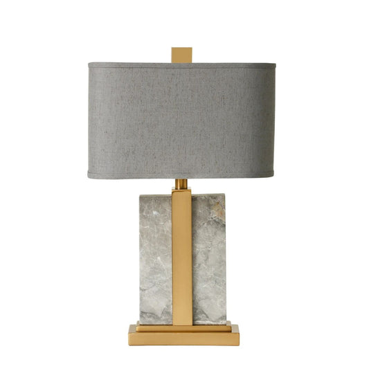 Art deco style lamp, a stunning design. The high point of this contemporary table lamp has to be its beautiful grey marble base an exquisite natural grain. The brass accents brings out the quality in the design. Finished with a rich slate grey linen shade.