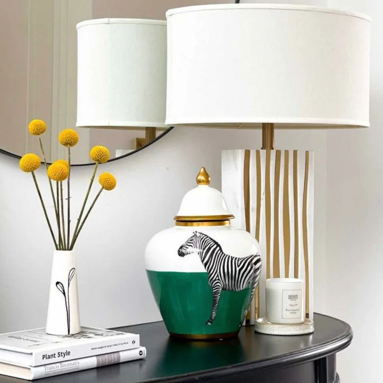 A smooth marble effect base combined with waves of brass details adds an organic feel to this lamp. The shade is unique in shape - oval with detail on top.