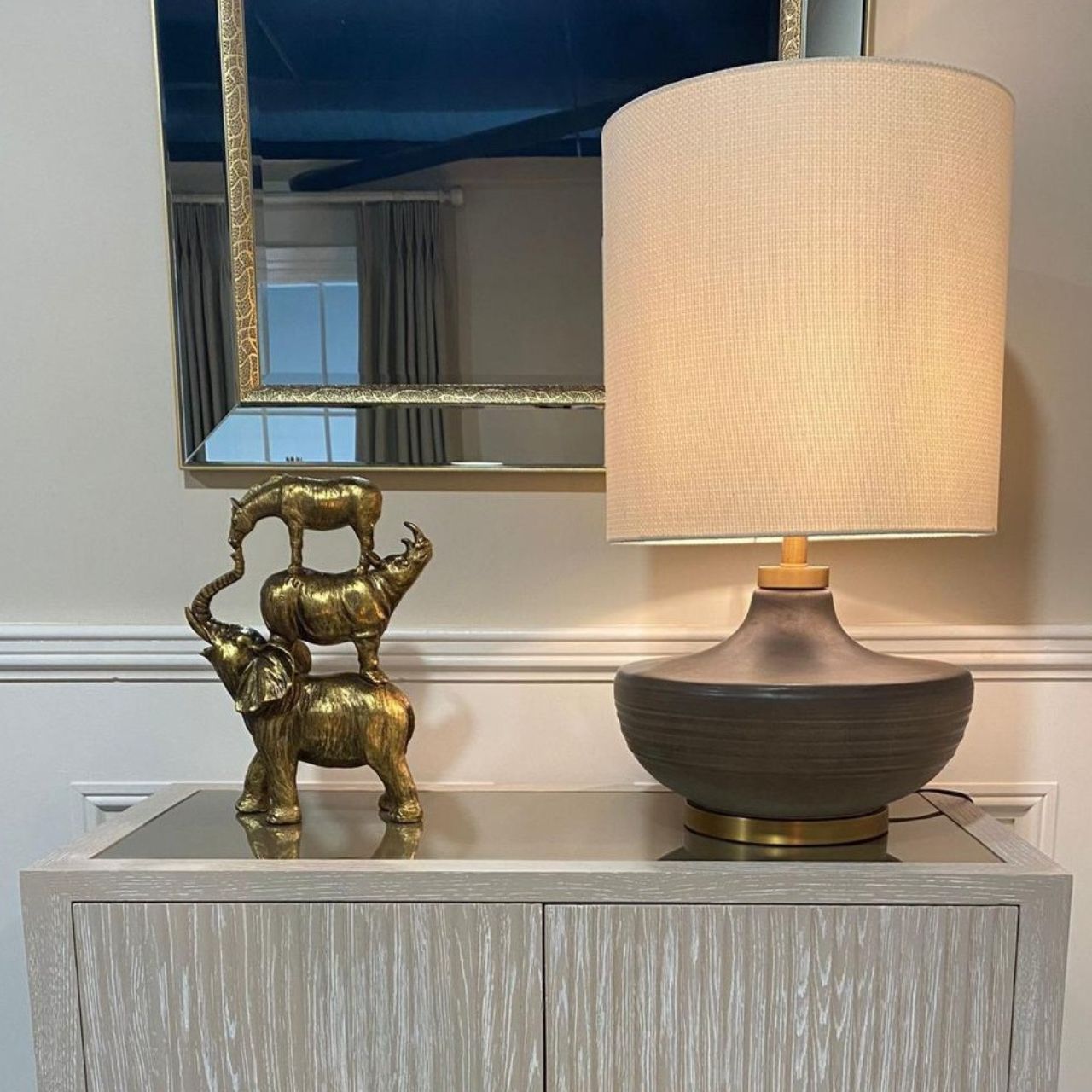 Presented in intricate detail and finished in elegant gold, this sculpture features a playful design of animals stacked on top of each other.