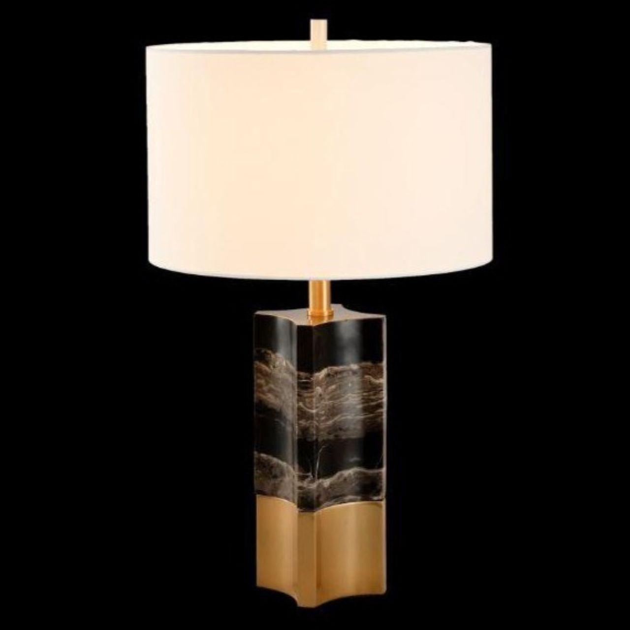 A show stopper. A unique marble base, a smooth finish, black and grey in colour with antique brass detail on the bottom of the lamp. Shape is not round which makes this lamp unique in is style. Curved styling seen on base of lamp. Beige lamp shade, cylinder in shape.