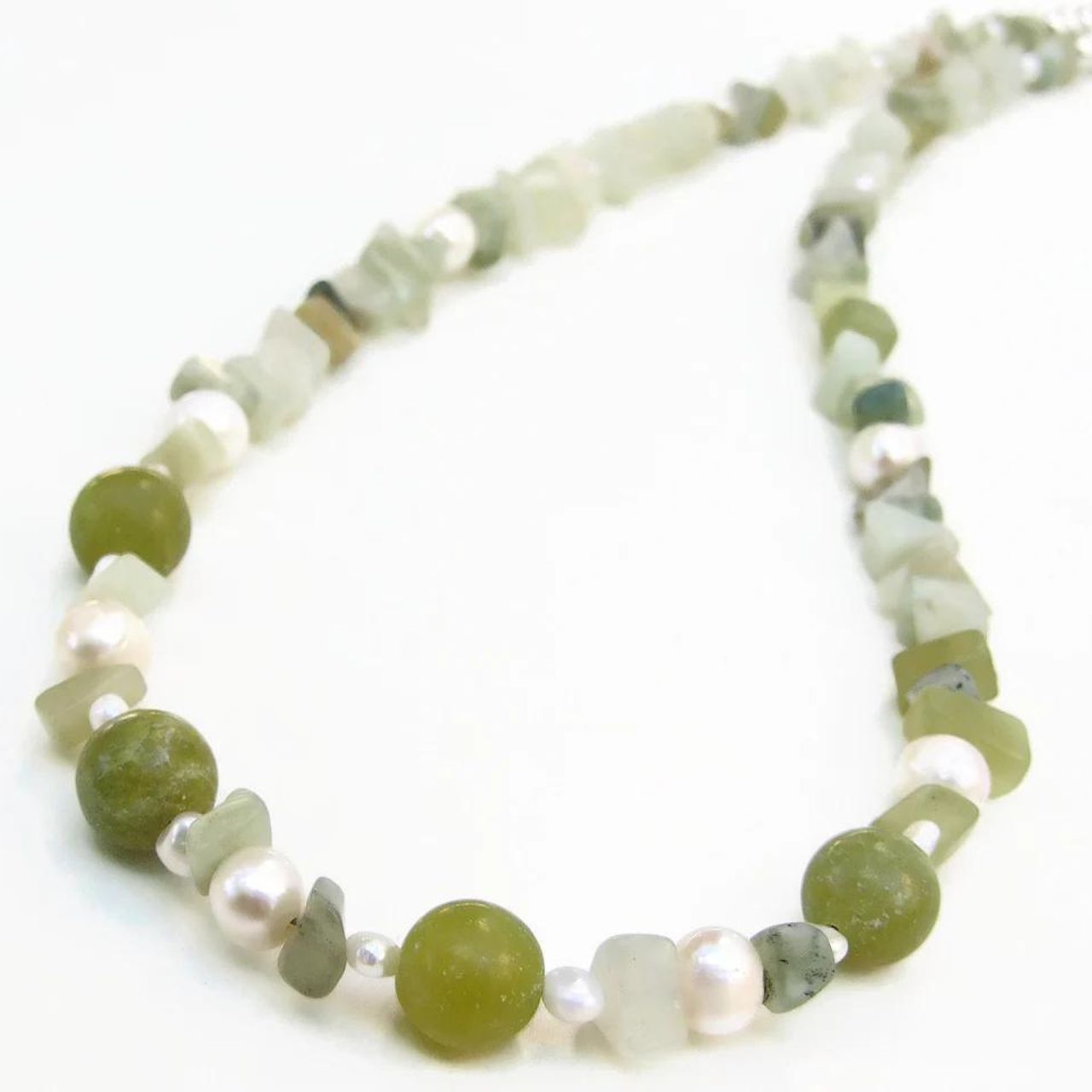 Jade has long been treasured especially in the East for jewellery, statues and trinkets. Its soft green lustre combines beautifully with natural Freshwater Ivory Pearls. This necklace uses a mixture of round Jade beads with a multitude of delightfully irregular chips.