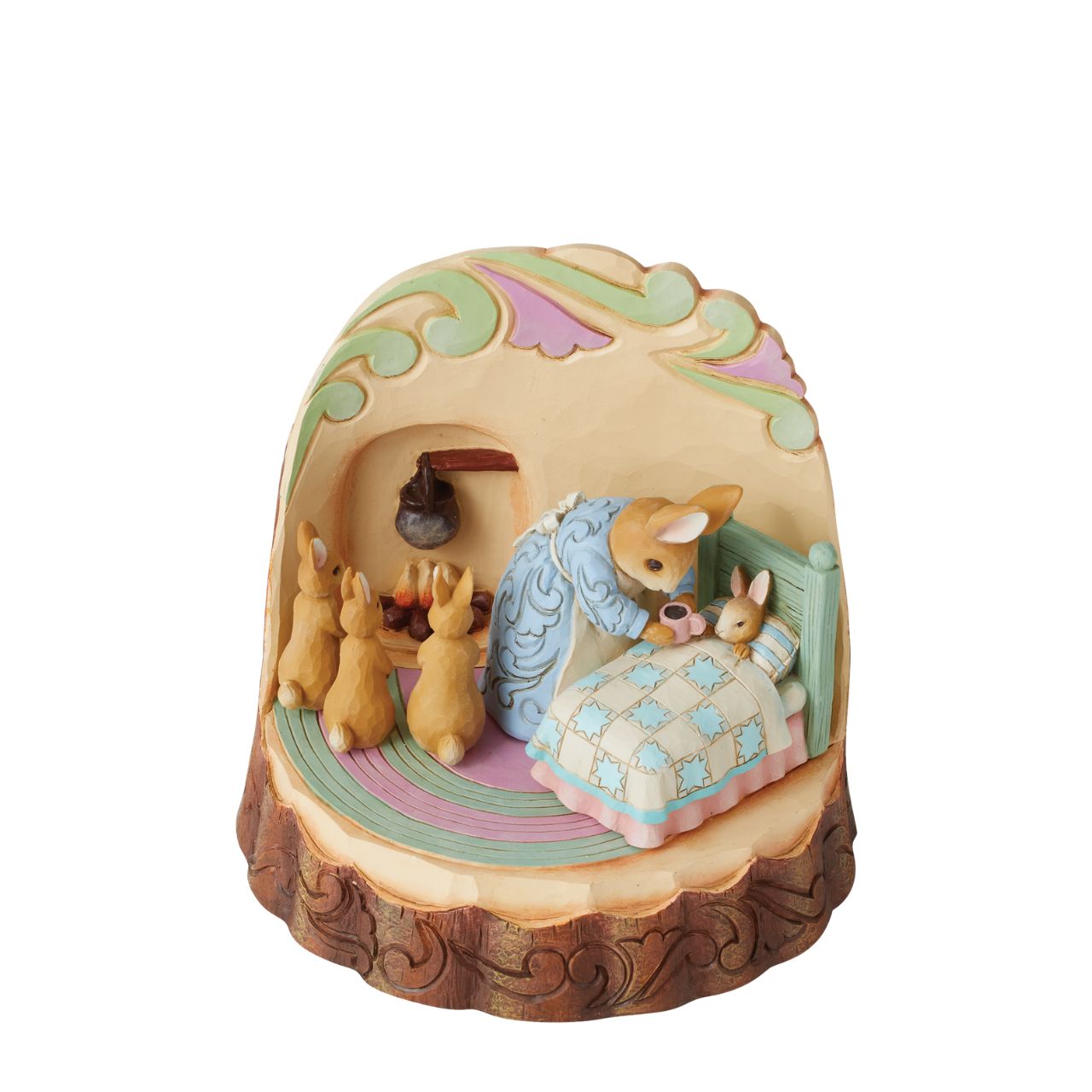 In this beautifully crafted figurine by Jim Shore, we get a glance inside the Rabbit household on a cozy night. Tucking her littlest bunny into bed, Mrs. Rabbit tends to sleepy child while her three other youngsters huddle excitedly by the fire.