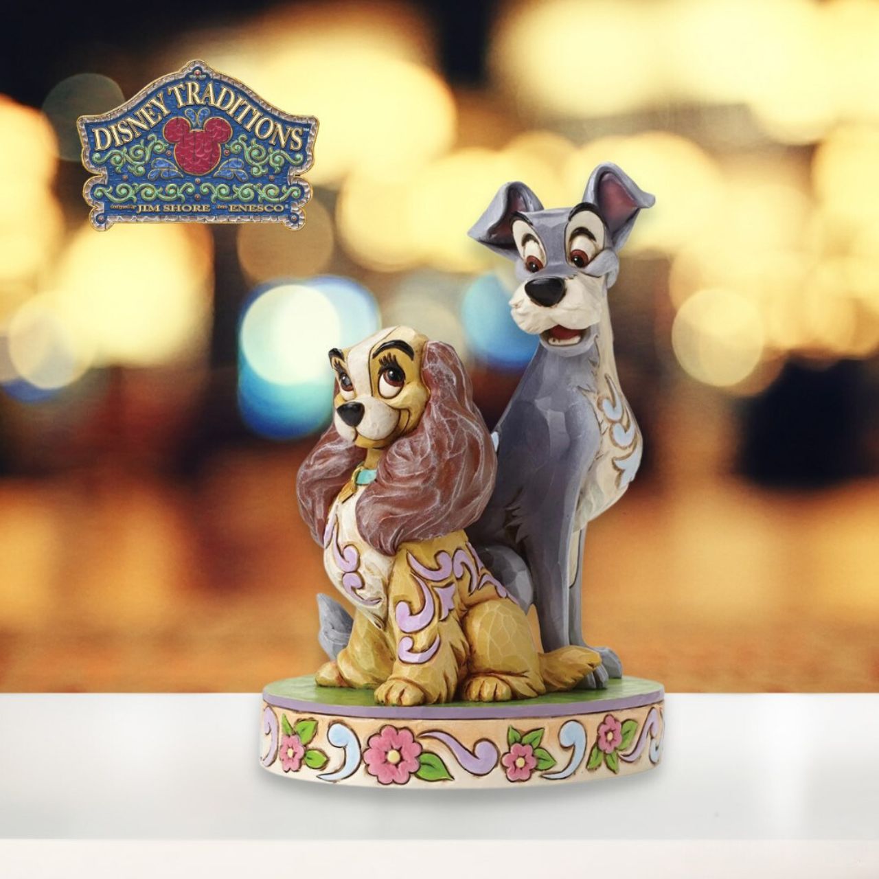 Opposites Attract Lady and The Tramp 60th Anniversary Piece  To celebrate the 60th Anniversary of Disney's romantic classic Lady and the Tramp. Jim Shore celebrates this historic milestone with a special figurine capturing the two characters in a lovable pose. Available only from the Disney Traditions brand.