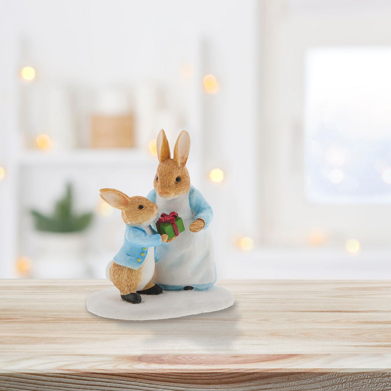 Beatrix Potter Mrs. Rabbit Passing Peter Rabbit a Present Figurine  Wish someone a very Merry Christmas with this beautiful, Mrs. Rabbit Passing Peter Rabbit a Present Figurine. This charming figurine would make a treasured keepsake over the festive period, and would be take pride of place in your home this Christmas.