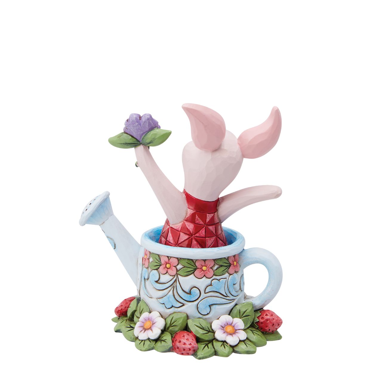 Piglet in a Watering Can Figurine  Introducing the delightful Piglet in a Watering Can Figurine from Disney Traditions by Jim Shore. Dressed in his signature pink jumper, this lovable character is holding a beautiful, pastel purple flower in his hand. This charming figurine is whimsical and heart-warming, bringing joy and magic to any collection of Disney figurines.