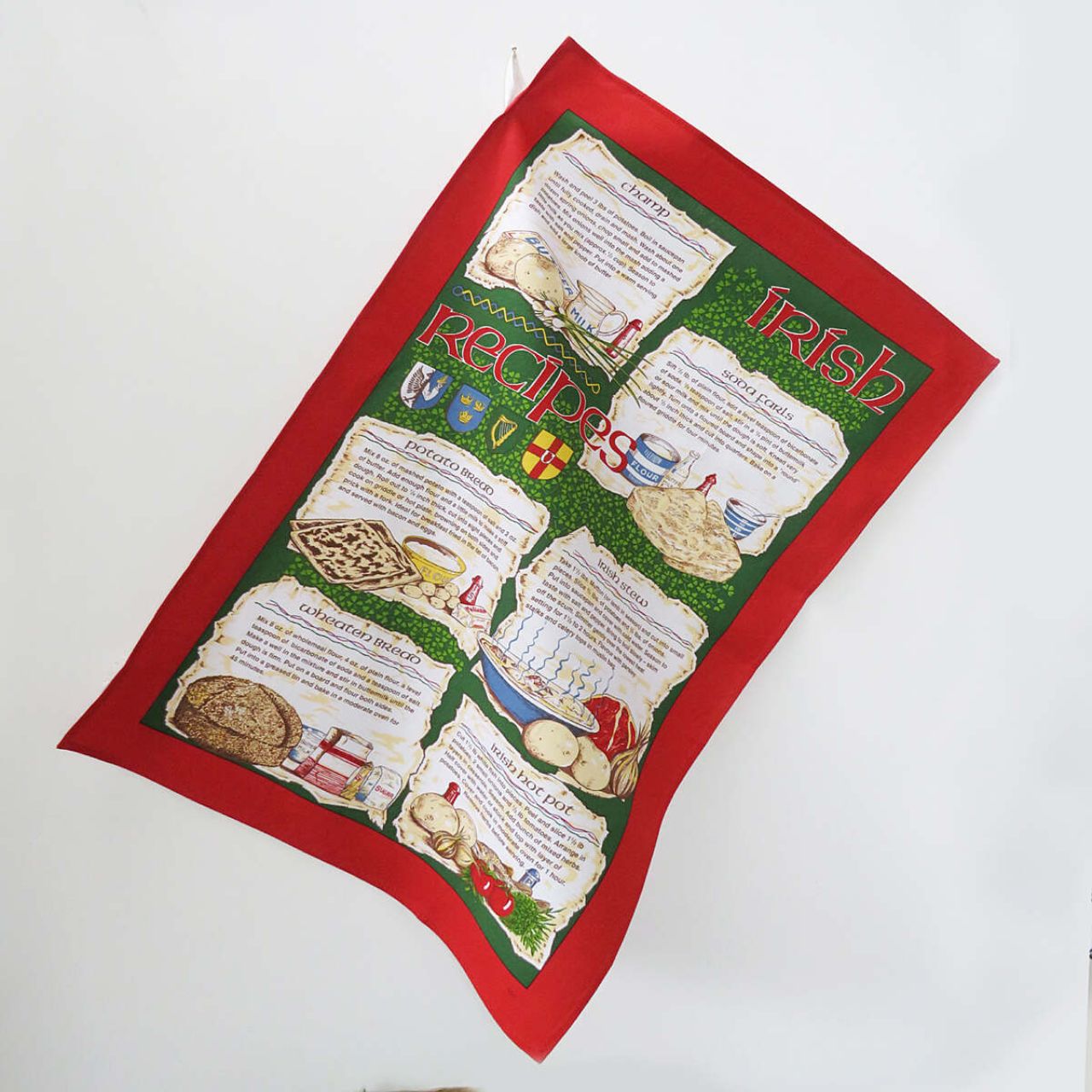 A traditional Irish tea towel inheriting a variety of well known Irish recipes. A beautiful Irish souvenir with vibrant red and green tones, including hand drawn and written motifs. Read easily whilst you cook with it's practical easy hang loop!