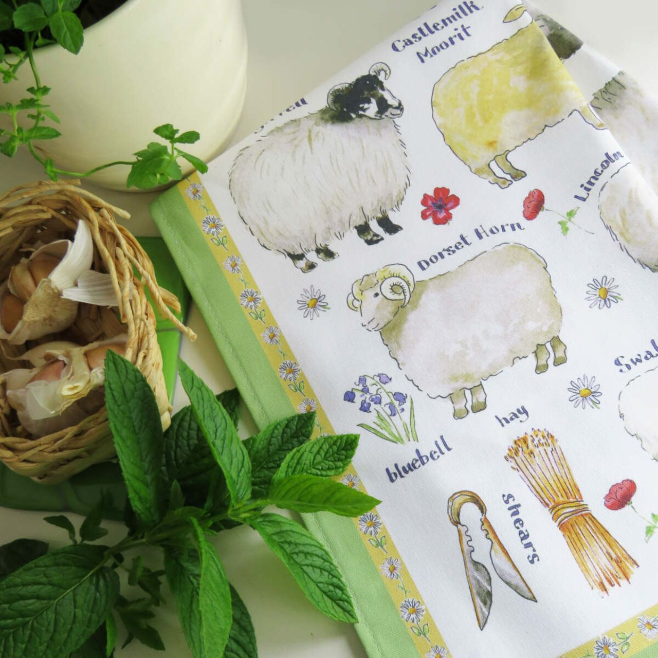 Inspired by our beautiful rural countryside, this hand drawn Cotton Tea Towel is perfect for any lover of farmyard animals. Displaying a variety of adorable Sheep Breeds, complimented by a vibrant green border.