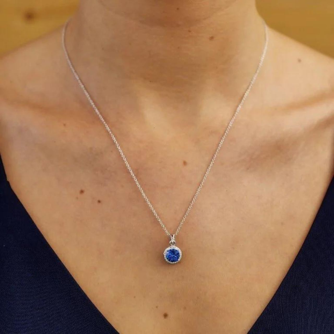 Round Silver Halo Pendant Adorned With Sapphire and White Crystals