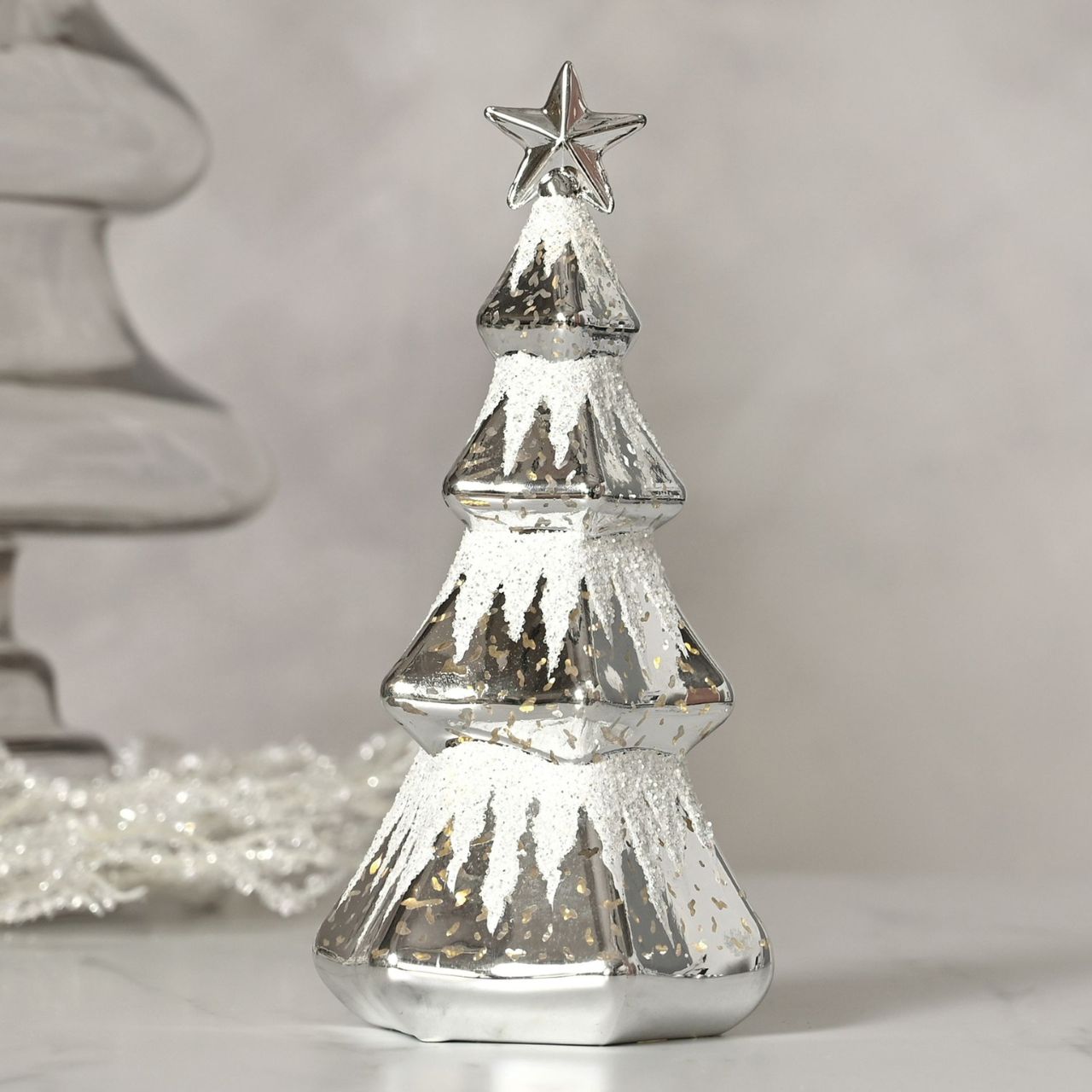 Silver Christmas Tree LED Light  A silver Christmas tree LED light by THE SEASONAL GIFT CO.  This shining silver tree provides gorgeous decoration for Winter Wonderlands at home.