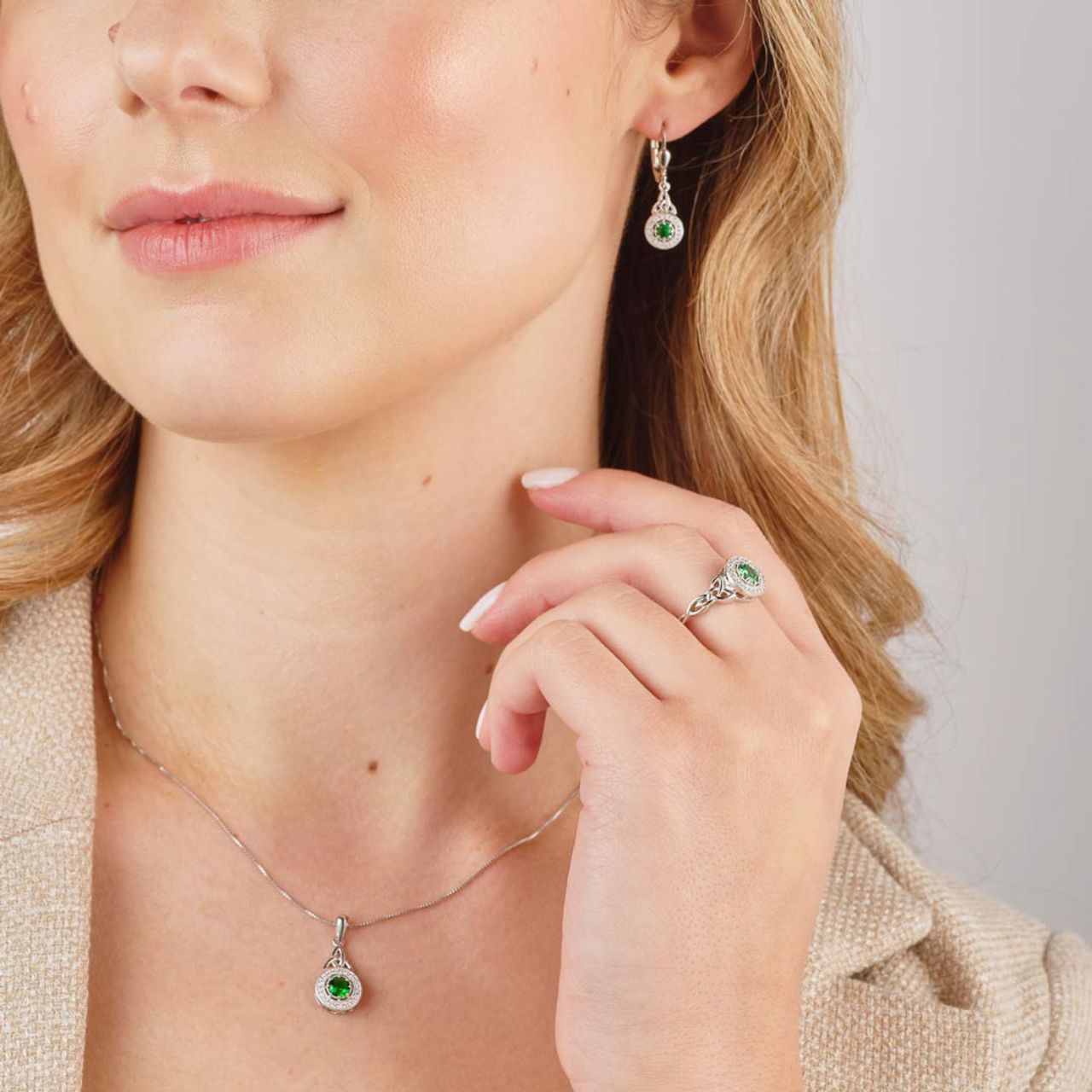 Crafted in sterling silver, these earrings contain a Trinity Knot drop which fall to an eye catching green cubic zirconia stone surrounded by a cluster of cubic zirconia. These sparkly Celtic drop earrings tells the tale of enduring love and have been designed to brighten up any look.