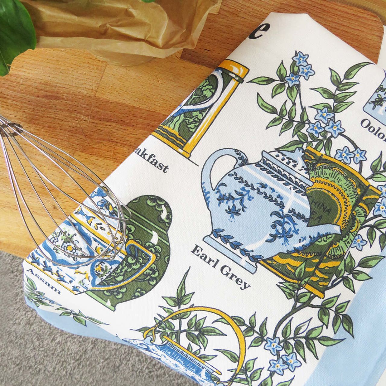 This beautifully hand drawn traditional Tea Time Cotton Tea Towel with elegant intricately designed crockery, complimented by delicate baby blue florals and earthy greens. This magnificent design is perfect for any lady or gent with a love of afternoon tea!