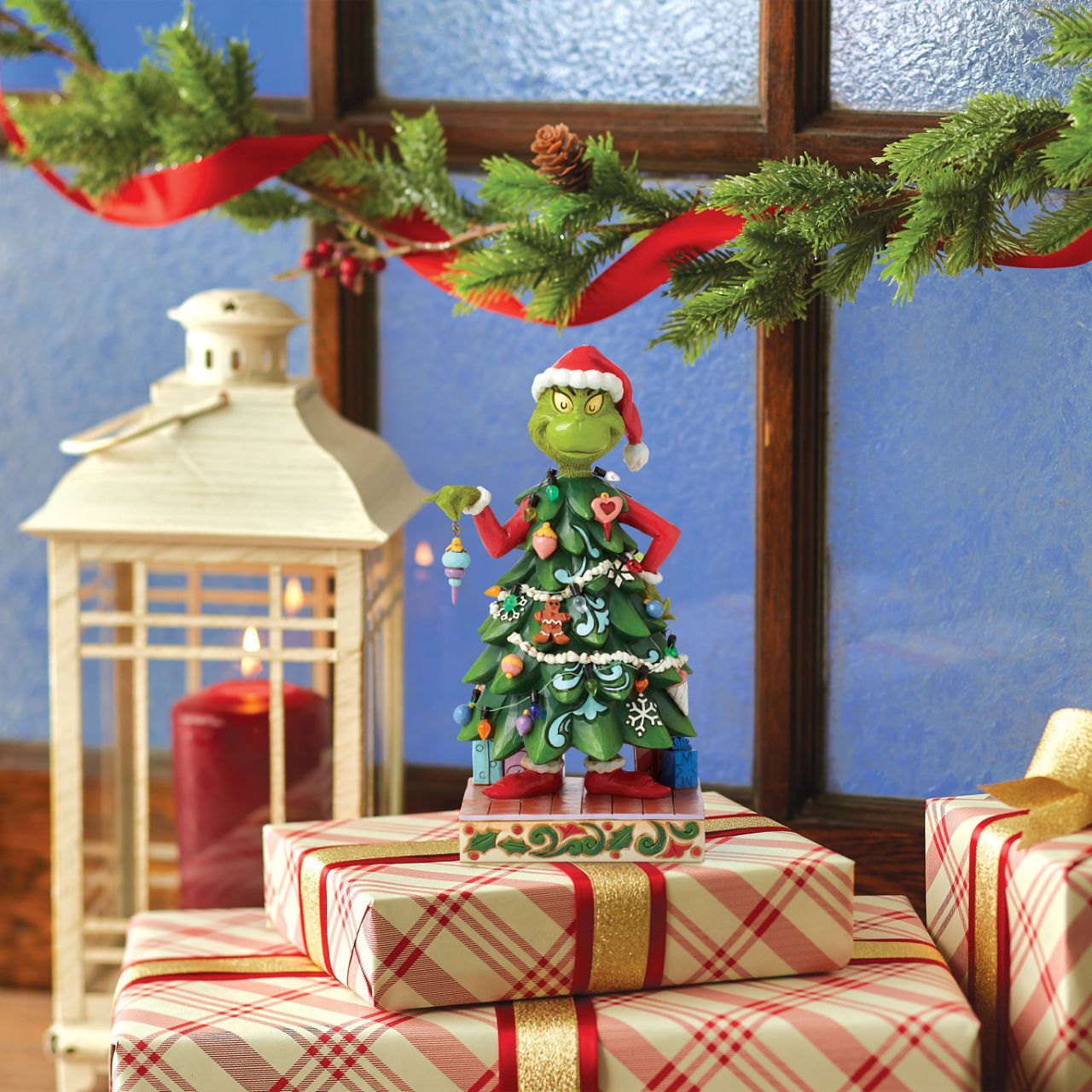 With a heart enlarged with holiday spirit and love, The Grinch smiles sincerely in this festive Jim Shore design. Dressed as a Christmas tree, Grinch wears a Santa hat and holds an ornament. This piece brings warmth to winter with decorative details.