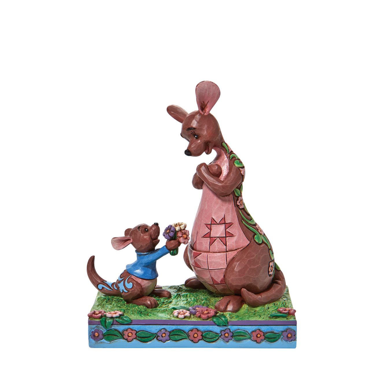 "The Sweetest Gift" The Winnie the Pooh crew enjoy Spring in the Hundred Acre Wood. Kanga and Roo pick wild flowers in the crisp morning air. Engraved with flowers and patchwork, the Jim Shore modelled kangaroo accepts her joey's freshly picked gift with a smile.