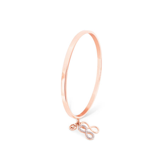 Infinity Bangle With Charms - Rose Gold by Tipperary  This bangle is a true show stopper, crafted from Rose Gold it has two dainty Infinity Motifs, one inset with Crystals and the other finished to a high polish. A TC Fob finishes off this fantastic piece.