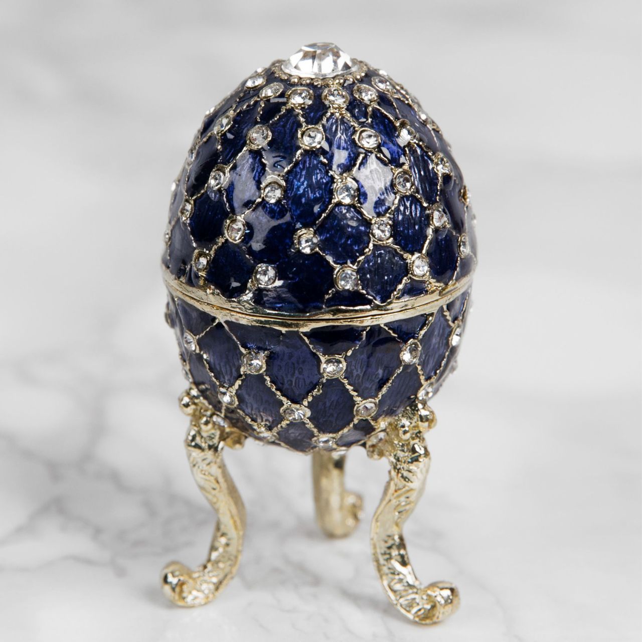 Painted in a resplendent blue colour with stunning gold and crystal patterns, this trinket box is a wonderful ornament to complement a mantelpiece, bookcase or cabinet.